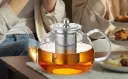 Glass-Teapot-with-Infuser-at-Table.webp