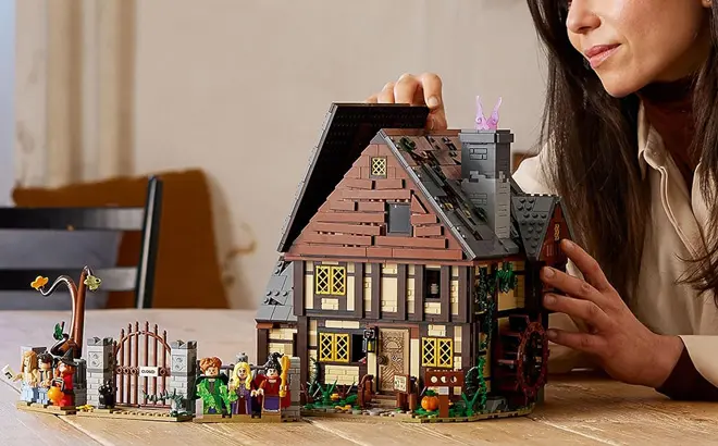 LEGO-Ideas-Hocus-Pocus-The-Sanderson-Sisters-Cottage-on-a-Table.webp